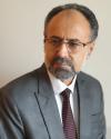 Headshot of Dr. Asefi looking to the right, wearing a suit
